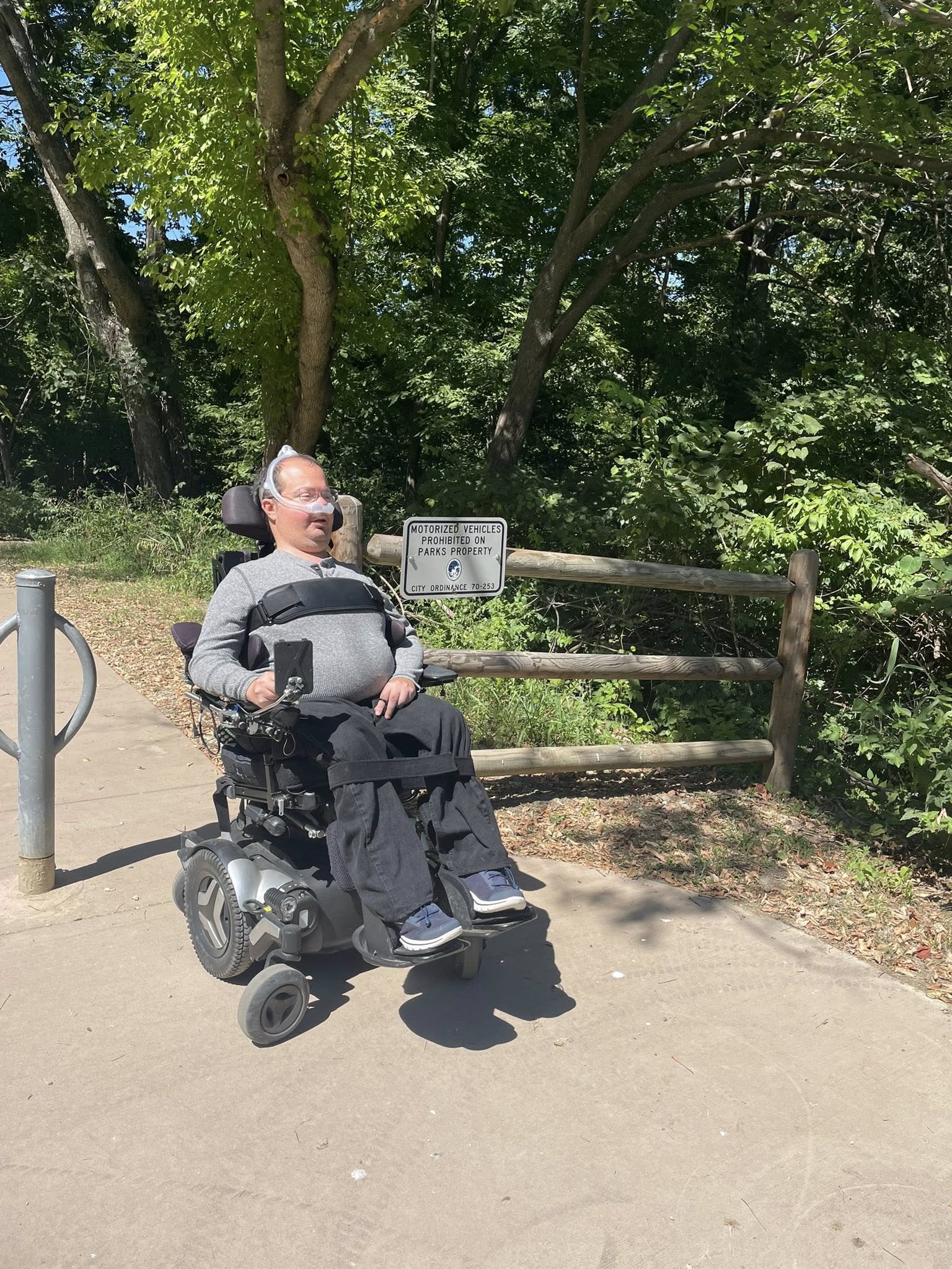 Ryan outdoors on an accessible trail